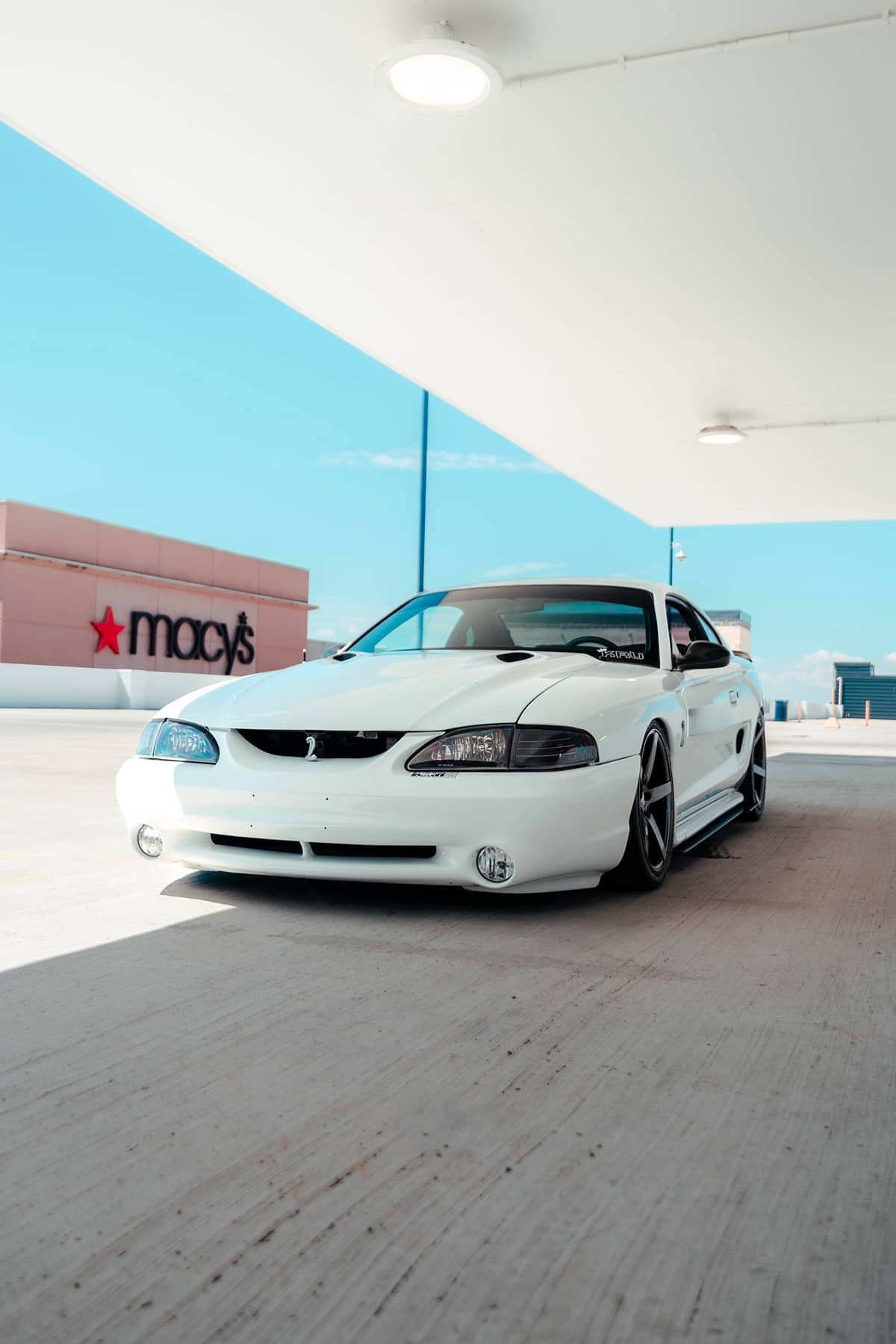 Lowered white ford mustang cobra SN95 with blacked out headlights