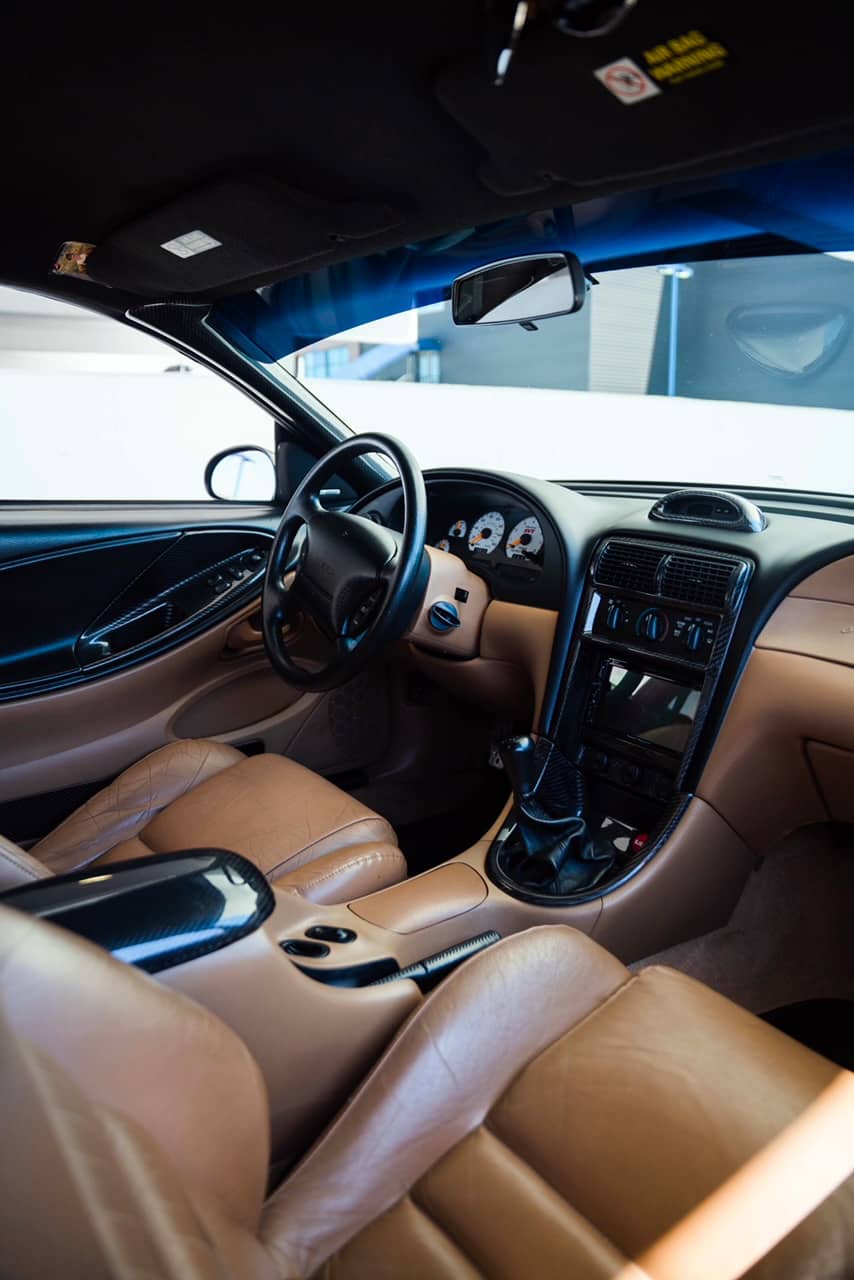 Original tan interior with Dark Horse Carbon dash